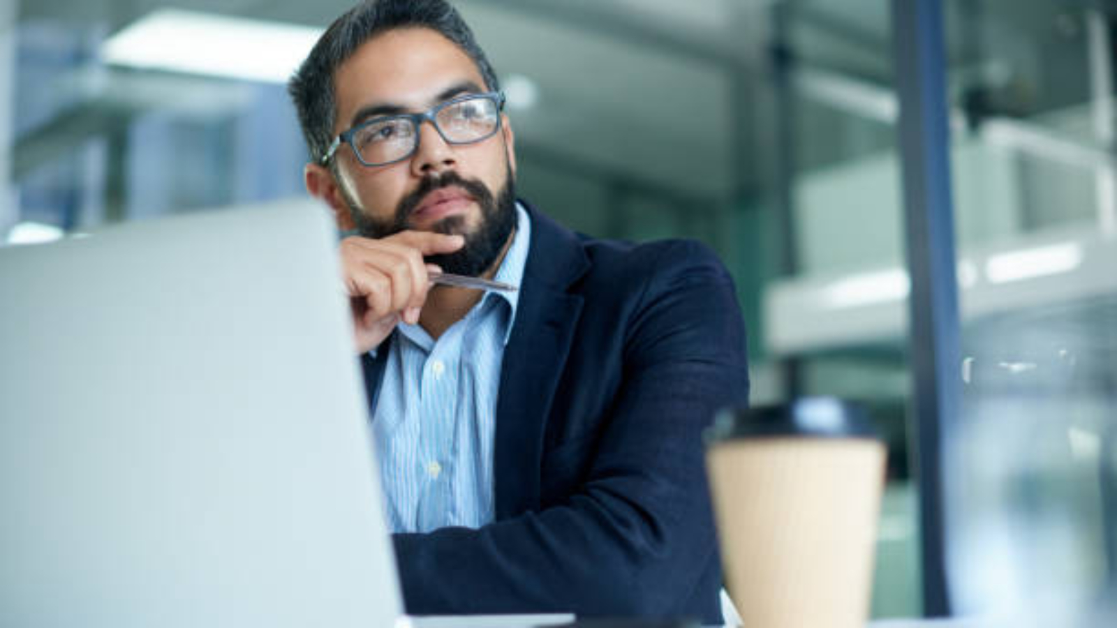 Shot of a mature businessman looking thoughtful while working on a laptop in an office